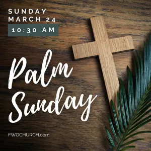 Cross on a table with a palm leaf